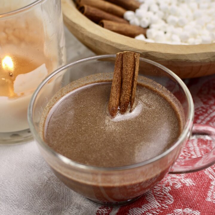 hot cocoa on a Swedish towel by a candle and bowl