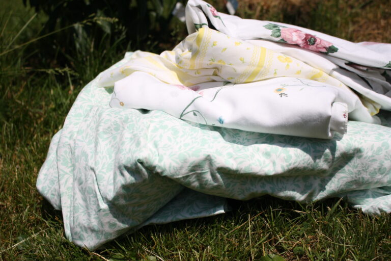 pile of floral fabric in the grass