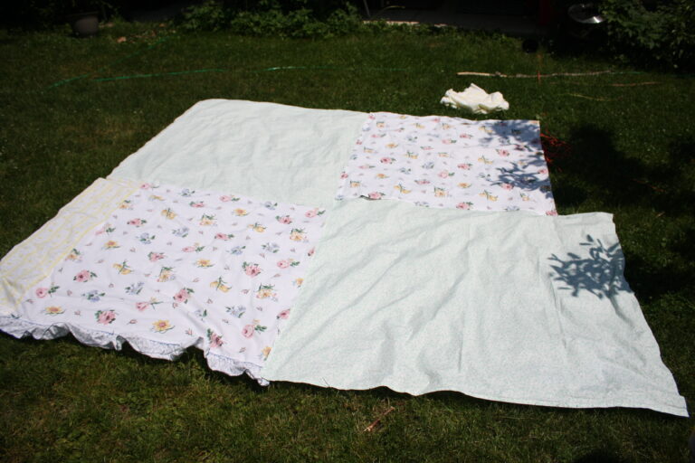 fabric for backyard tent laid out on grass