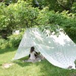 Kids playing in tent outside