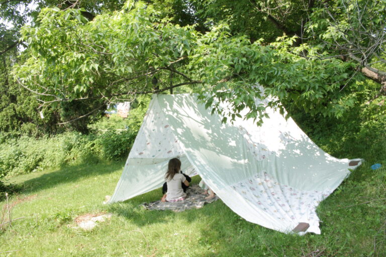 Kids playing in tent outside