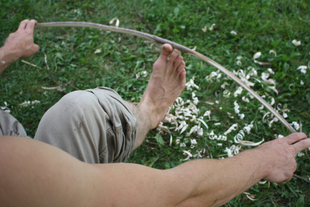 testing a toy wooden bow