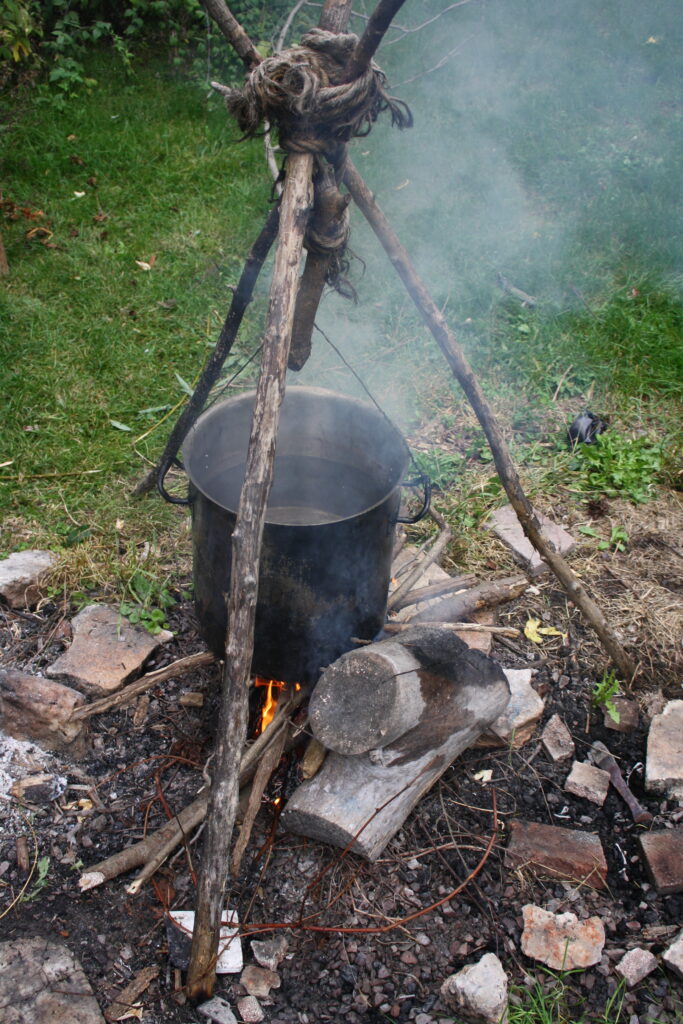 Pot of water used for brewing beer, suspended over a fire.