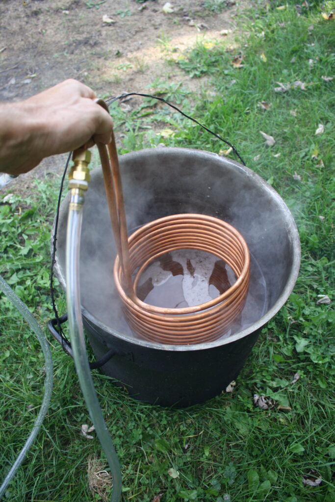 a beer-brewing cooling coil going into a pot of hot wort