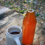 bottle of beer and mug filled with beer on a wooden table