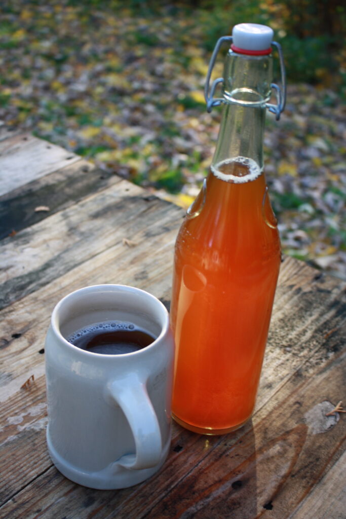 bottle of beer and a mug of beer on a wooden table