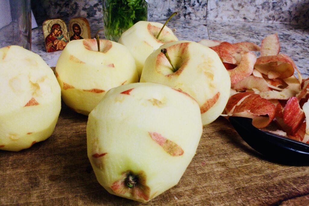 peeled apples sitting on cutting board