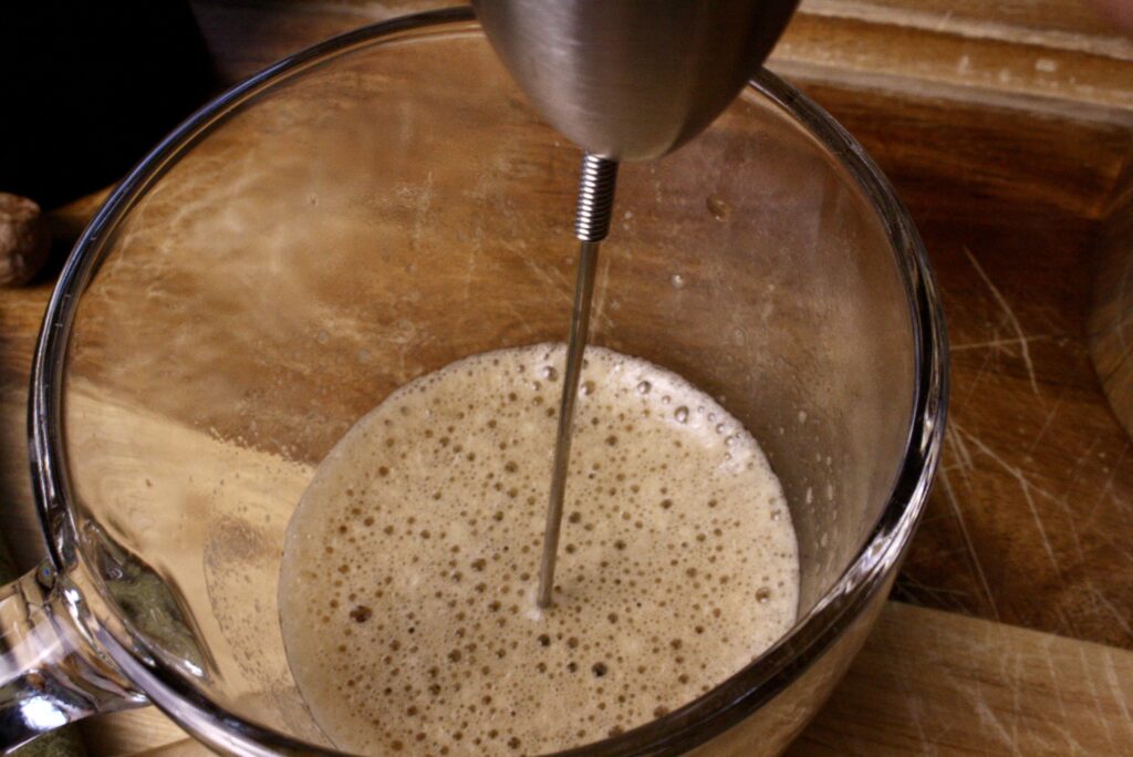 Electric whisk blending coffee