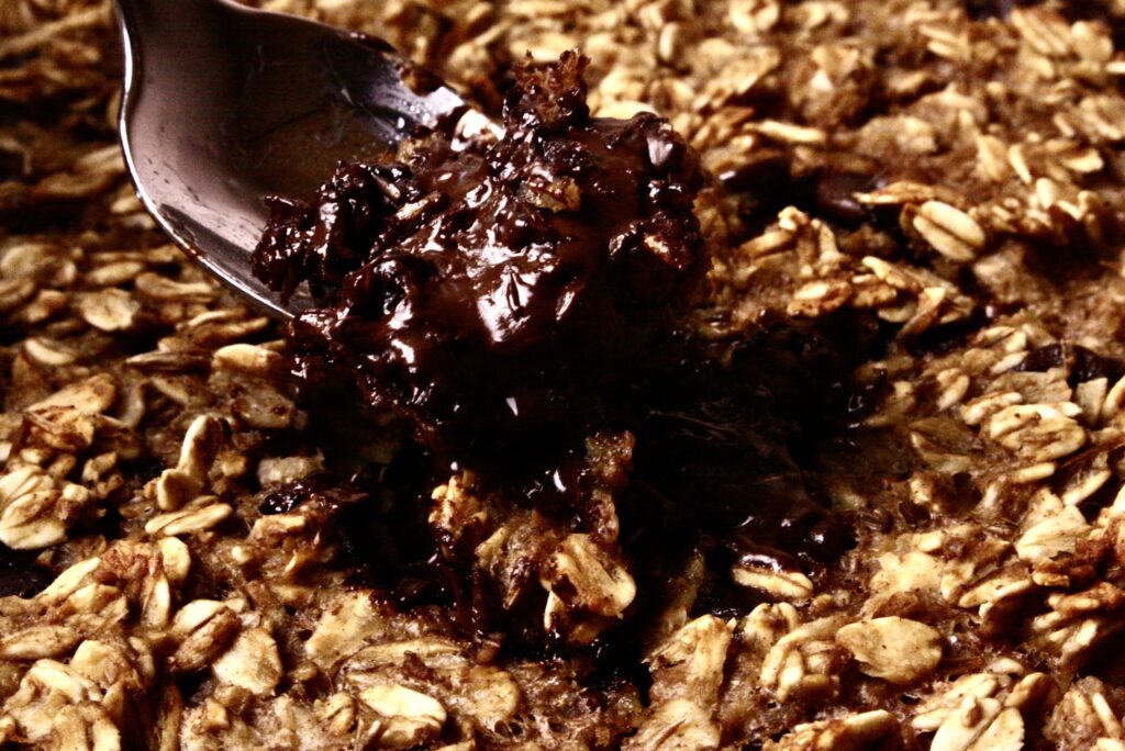 fork taking a scoop of chocolate out of baked oatmeal