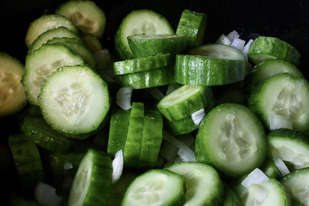 sliced cucumber and minced onions in a bowl