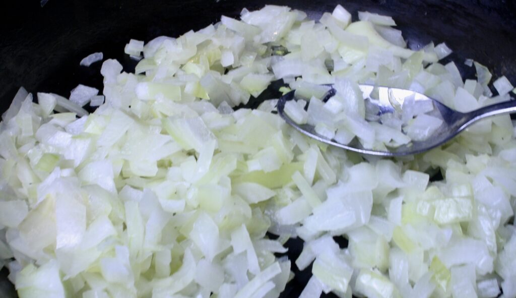 onions caramelizing in a cast iron skillet