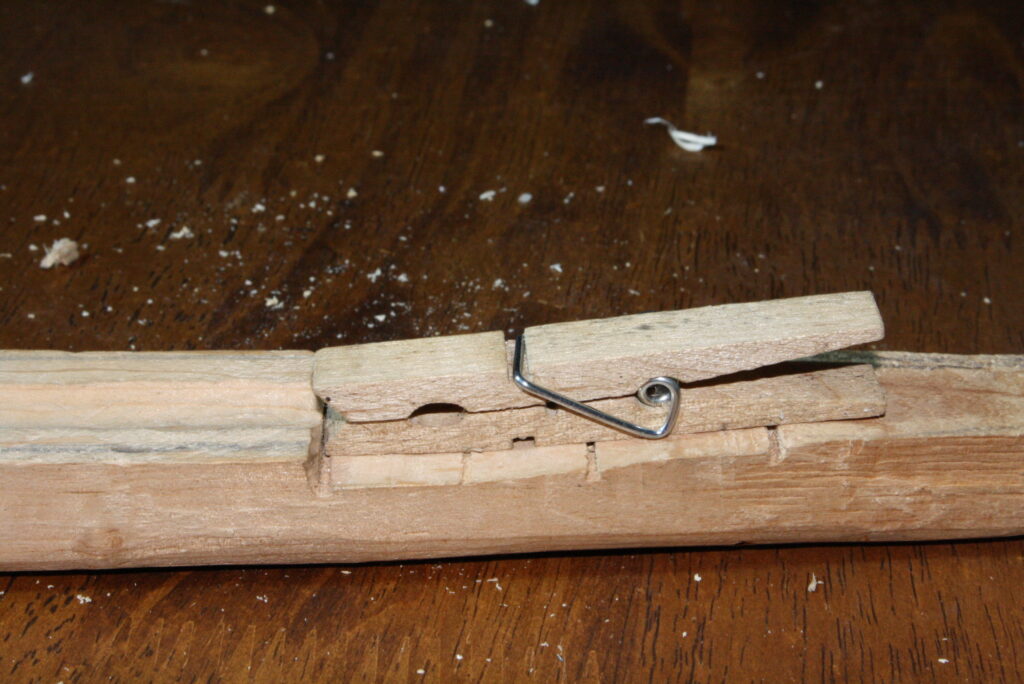 close-up of a clothes pin attached to the wooden stock