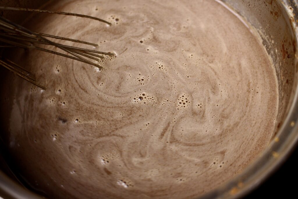 whisk stirring hot cocoa in a pan