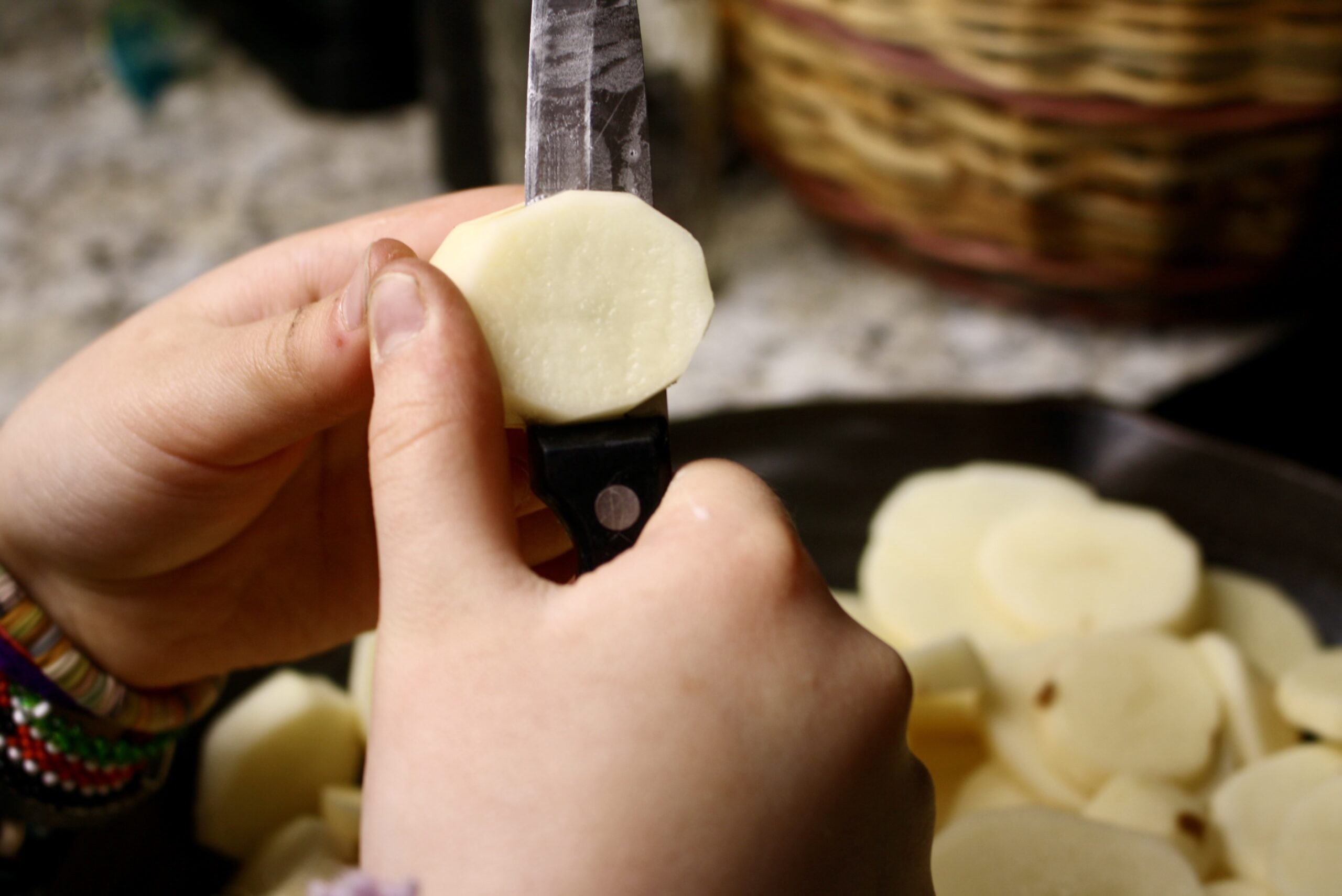 hand slicing potatoes