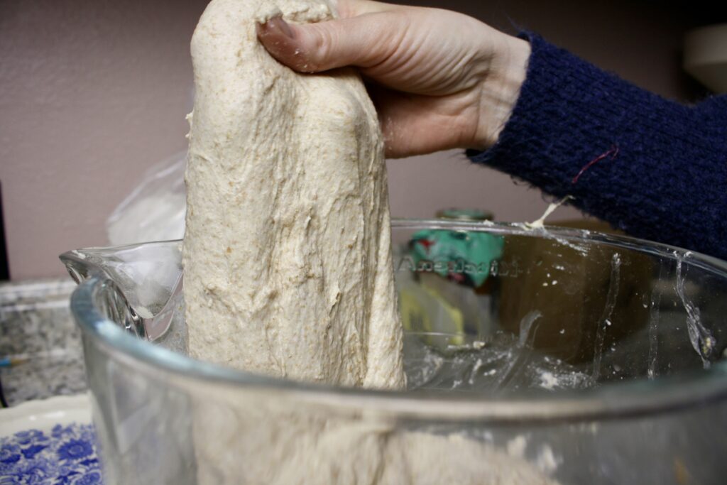 hand stretching sourdough dough