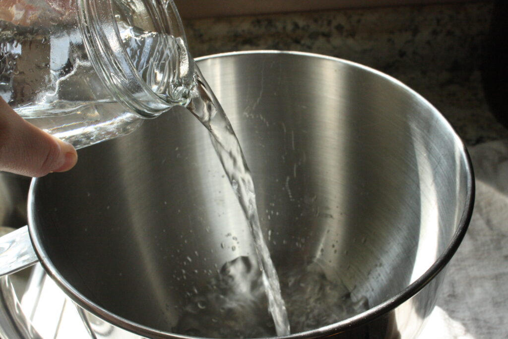 hand pouring water into a bowl