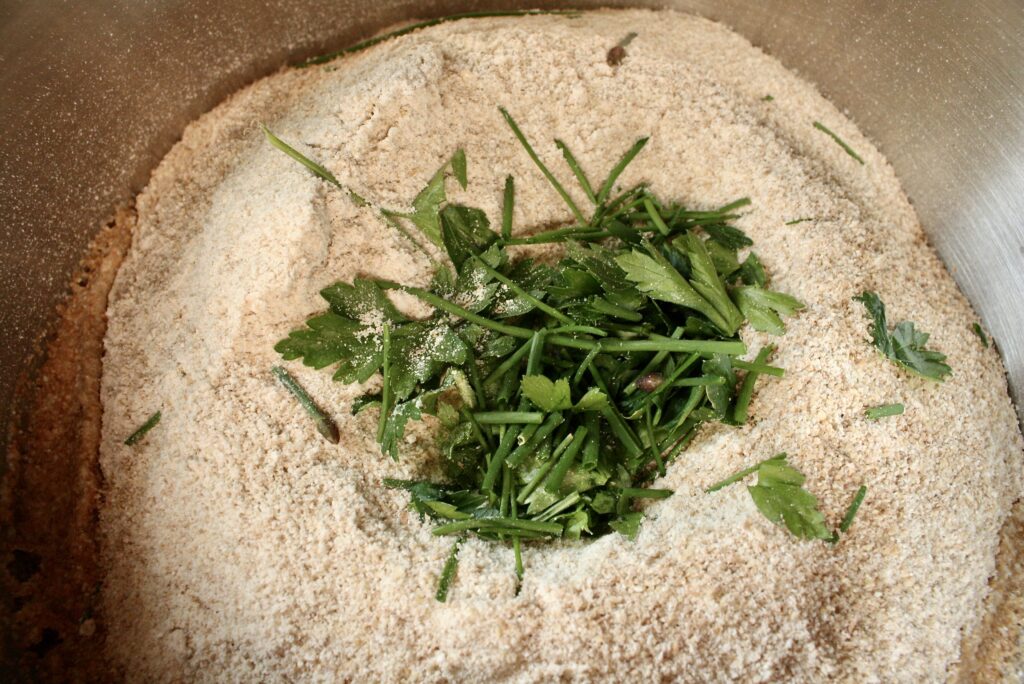 fresh herbs sitting in flour in a bowl