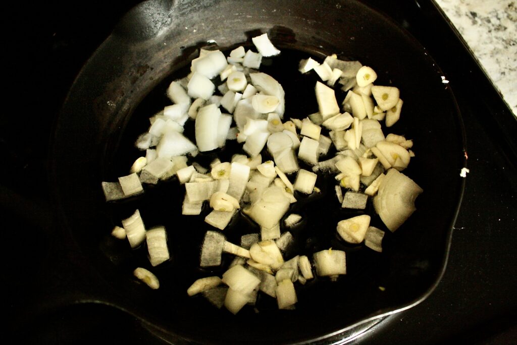 onions caramelizing in a cast iron skillet