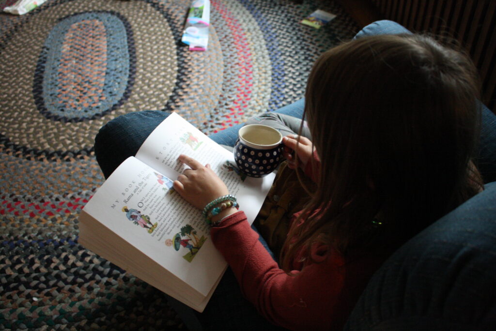 girls reading a book with a cup of tea