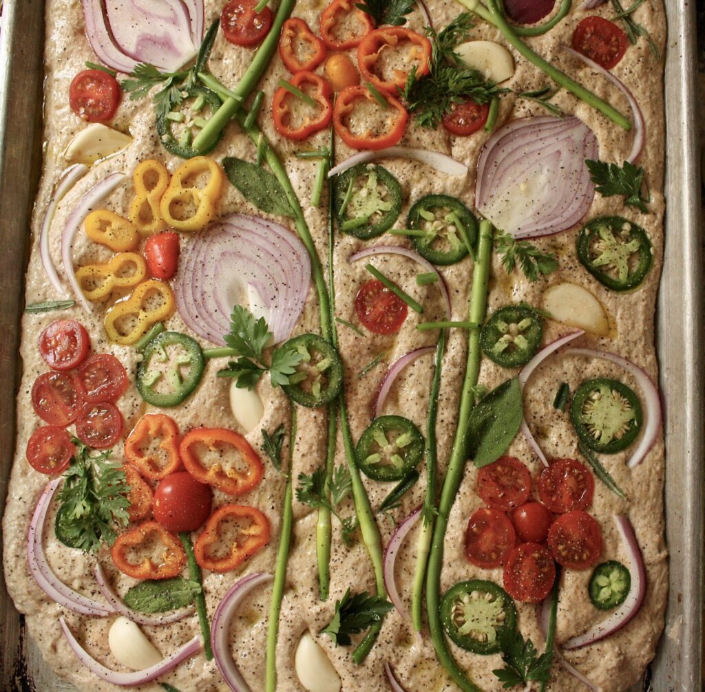 Sourdough focaccia with flower designs made out of garden veggies