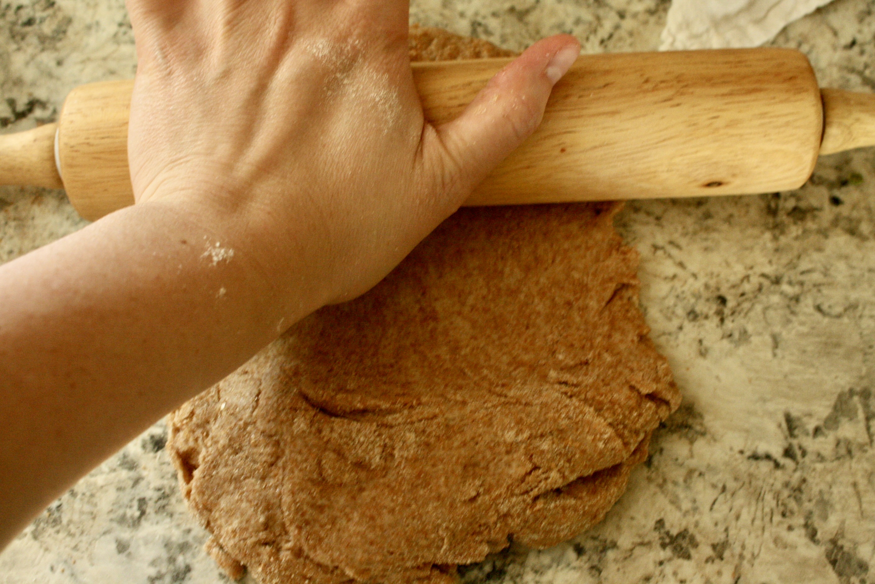 hand rolling out dough