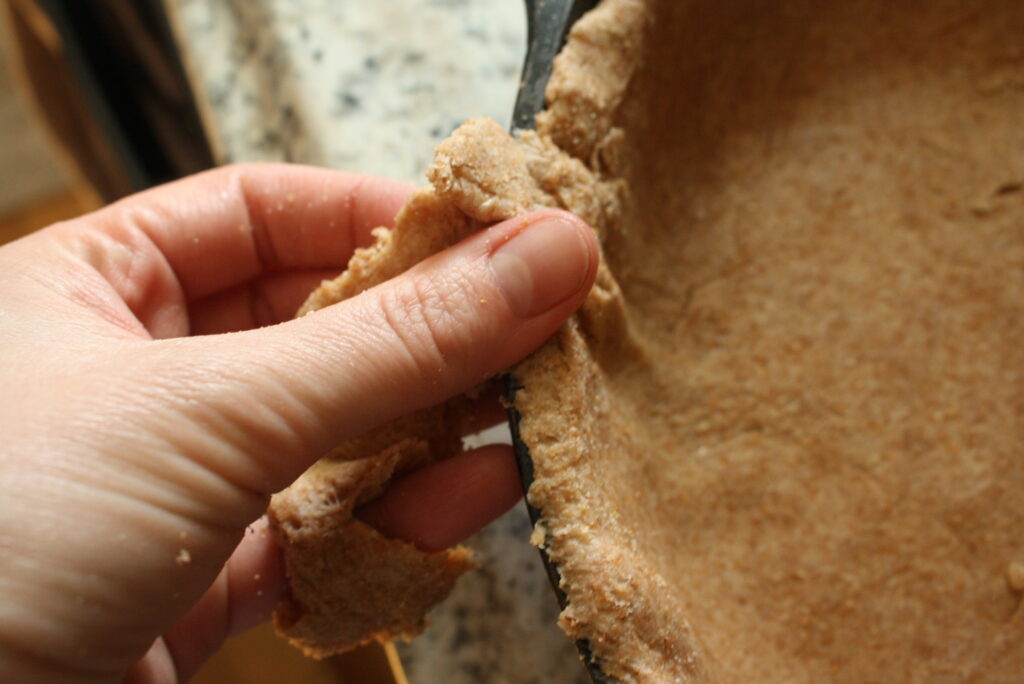 hand pinching off dough