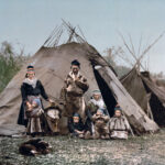 old photograph of a Sami family standing in front of their tent