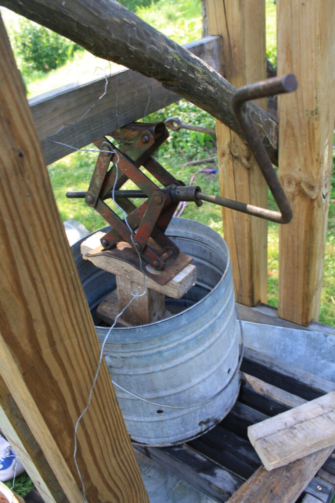 car jack being used in an apple cider press