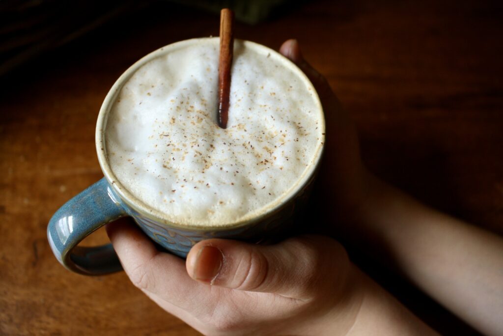 hands holding a mug of chai