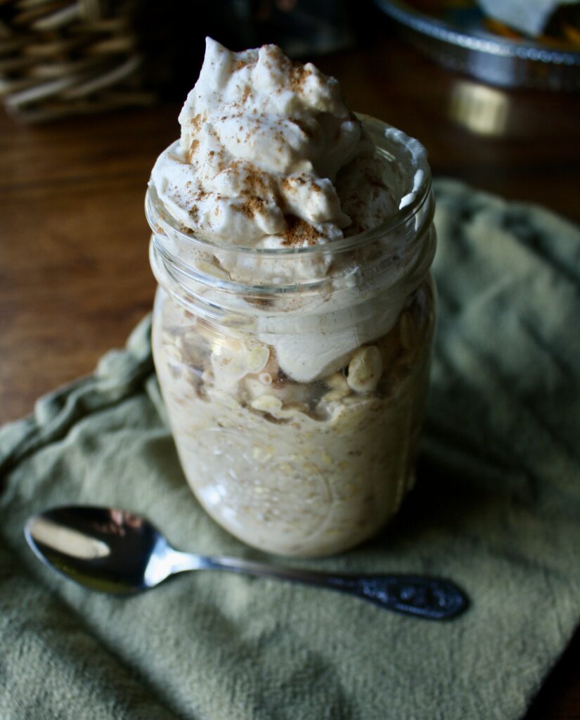 oats in a jar with whipped cream on top