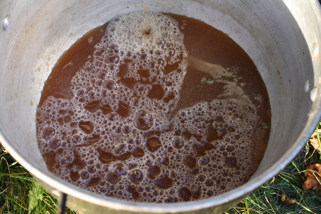 bubbly apple cider in a metal pot