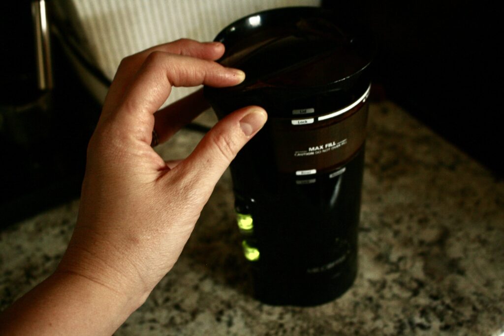 hand grinding on a coffee grinder