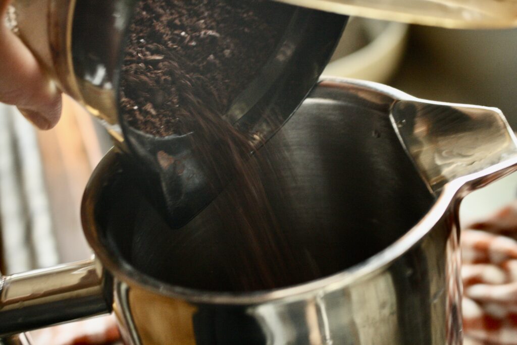 coffee grounds being poured into French press