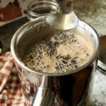 coffee ground floating on water in a French press