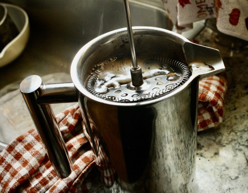 mesh filter of French press pressing coffee down