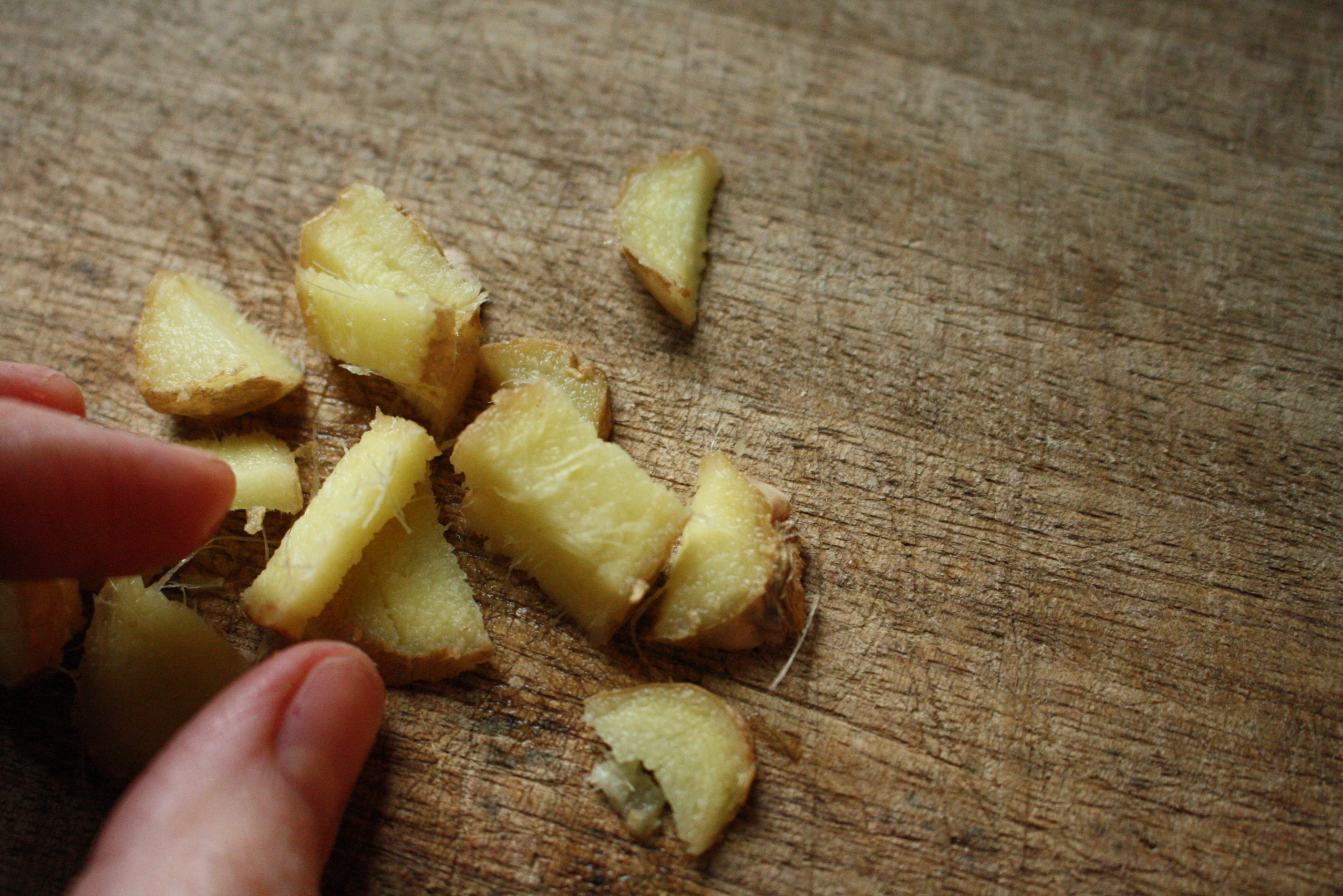 fingers by chopped pieces of ginger