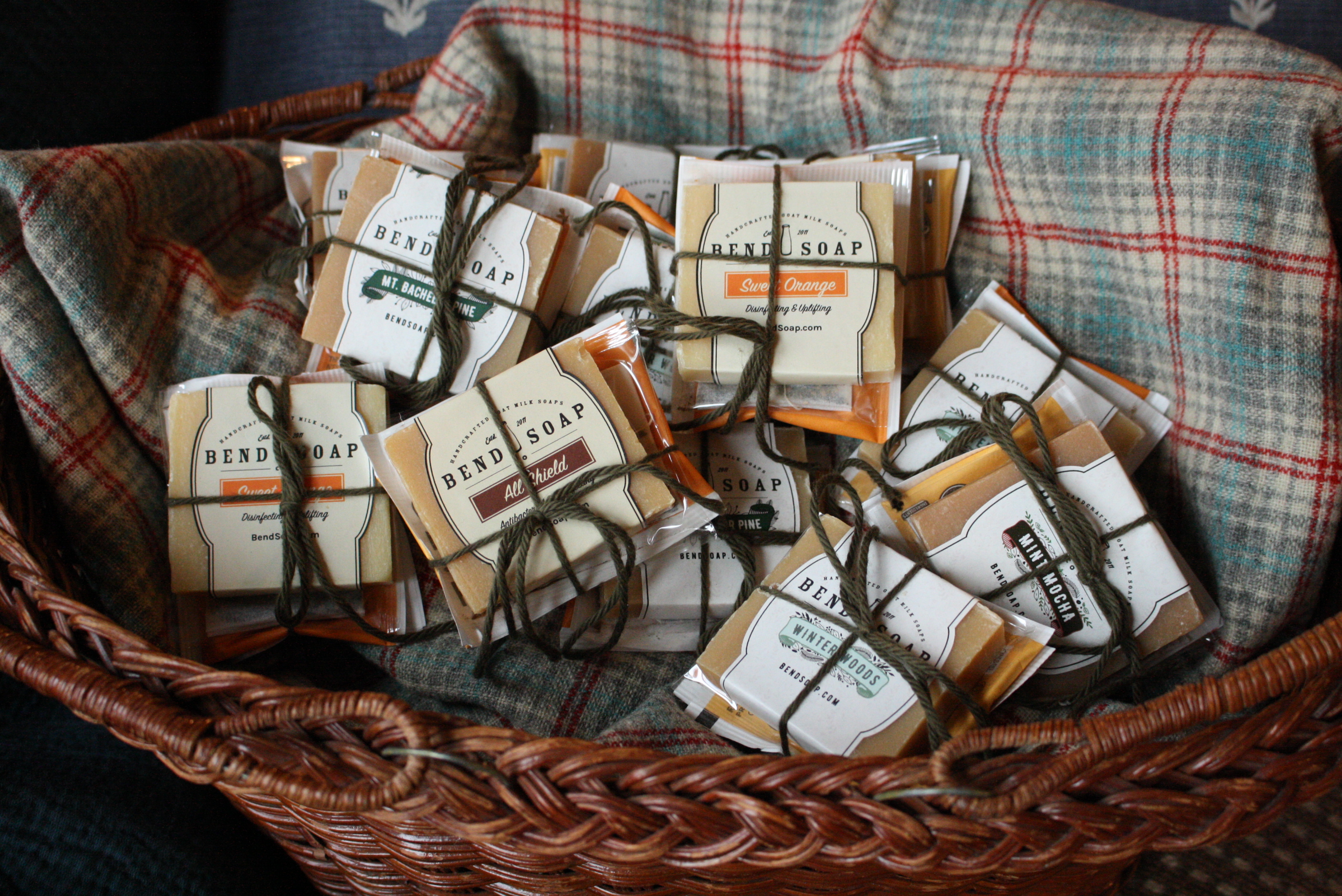 Basket of bundles of tiny soap bars with tea bags tied to them