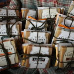 little packages of soap and tea bags tied up in a basket