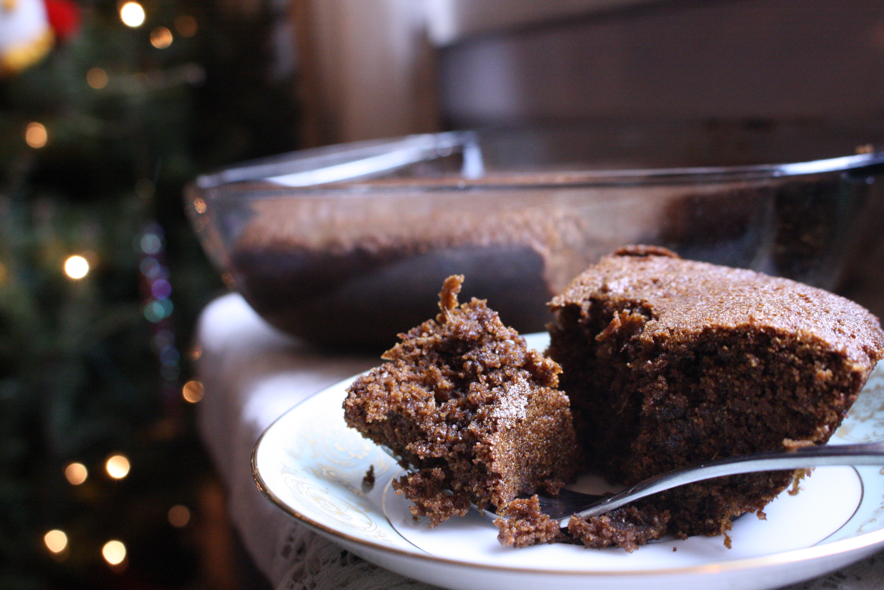 slice of gingerbread on a plate with a bite on a fork