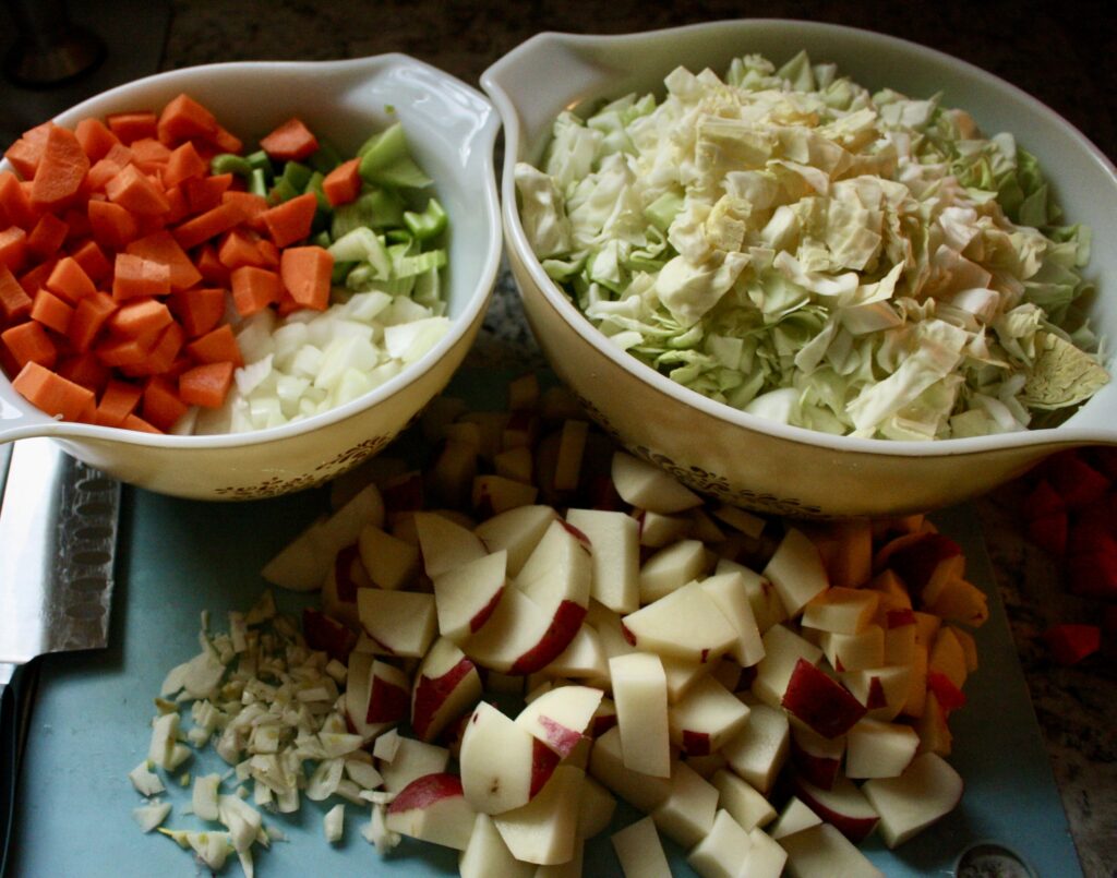 ingredients for pasty filling chopped in bowls and on a cutting board