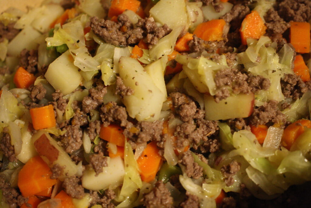 beef, potatoes, onions, cabbage, and carrots mixed together