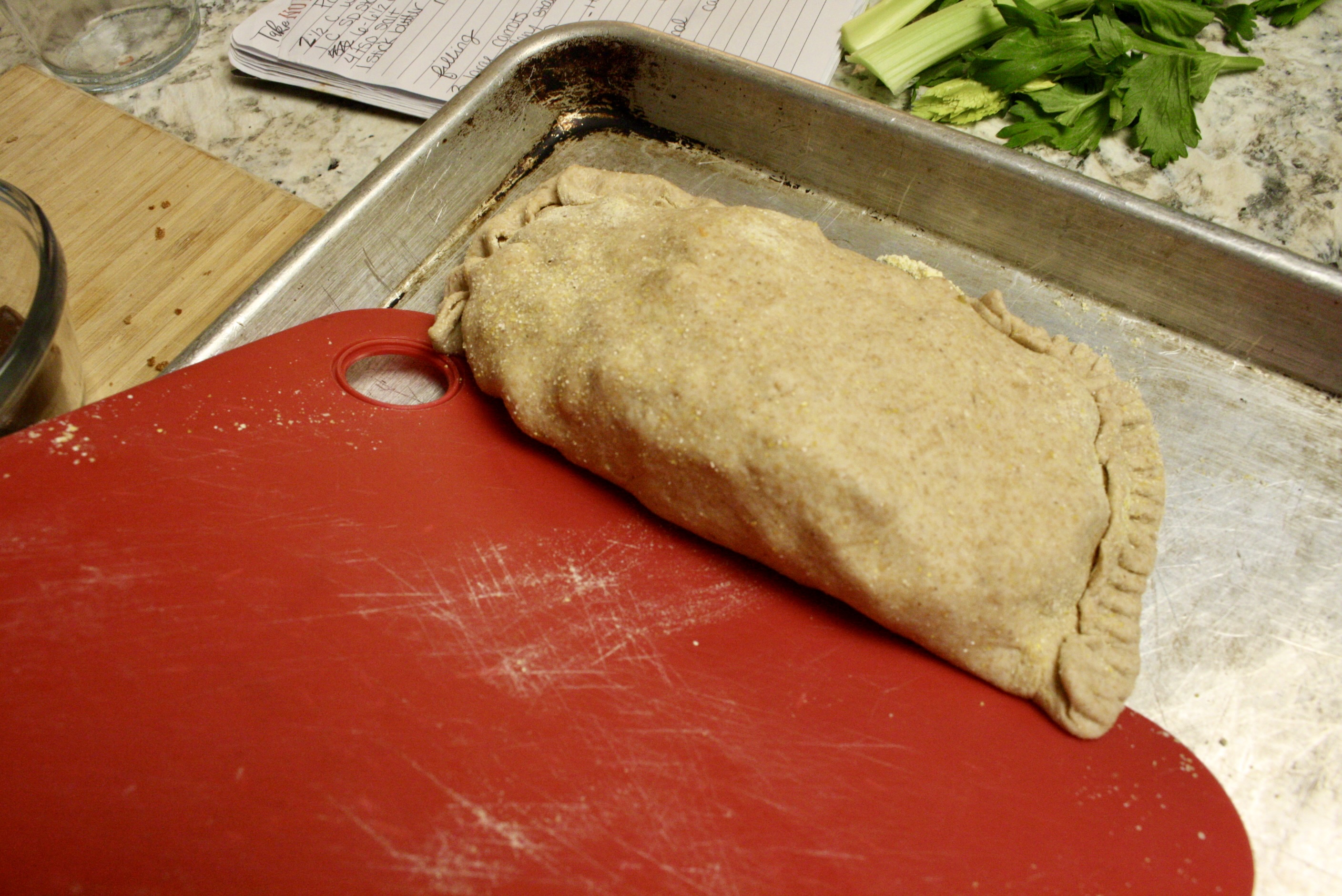 pasty being slid onto a baking tray