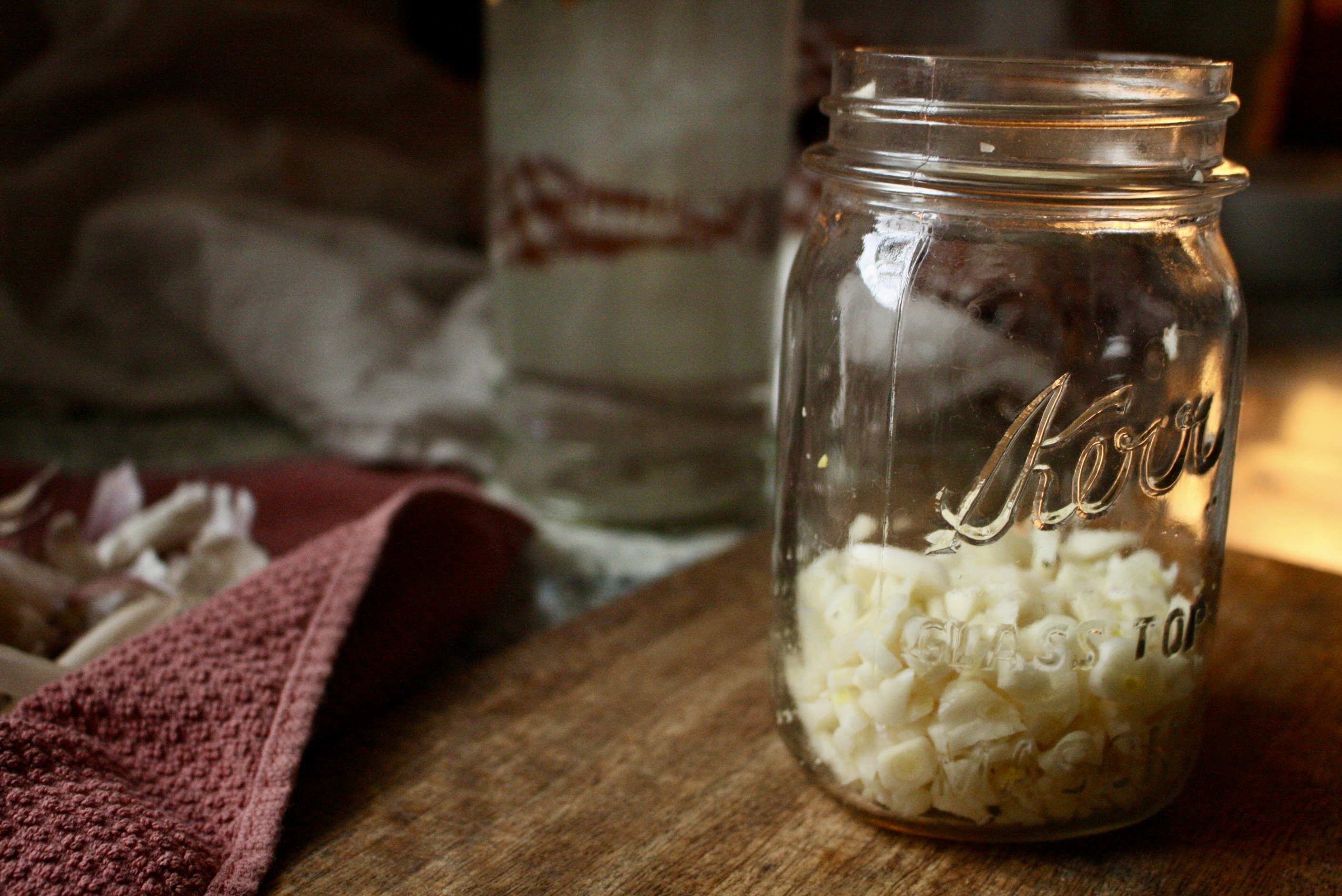 one cup of minced garlic in a glass pint jar