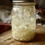 garlic swirling in a jar of vodka