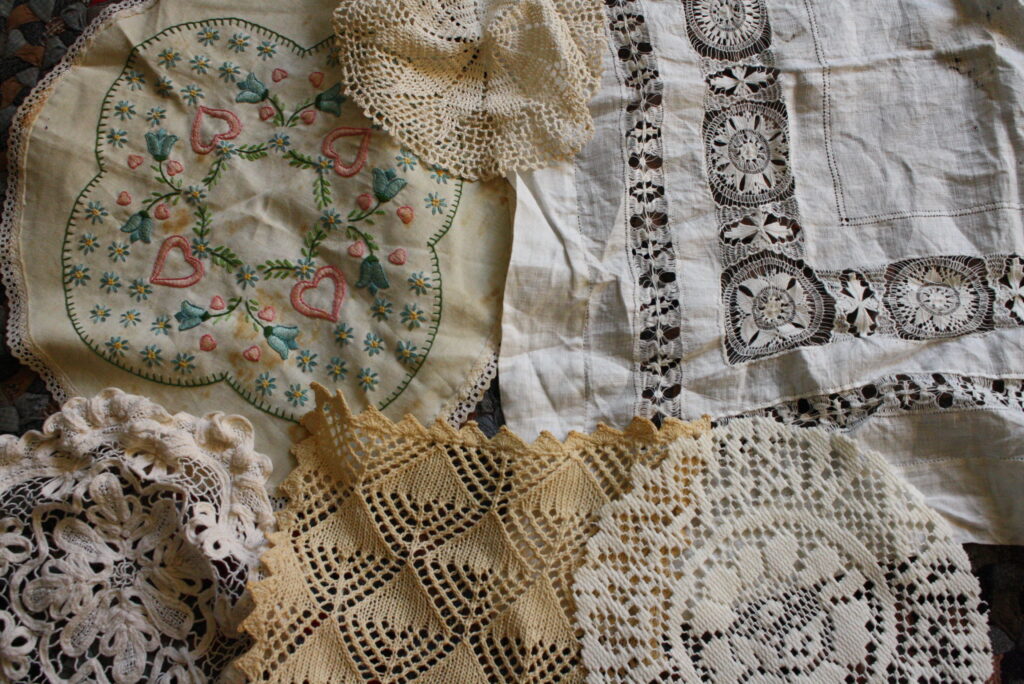 an assortment of lace doilies laid out on the floor