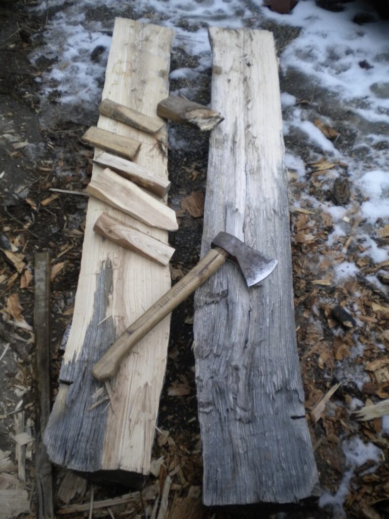 a split ash log for skis with four wedges and an axe.