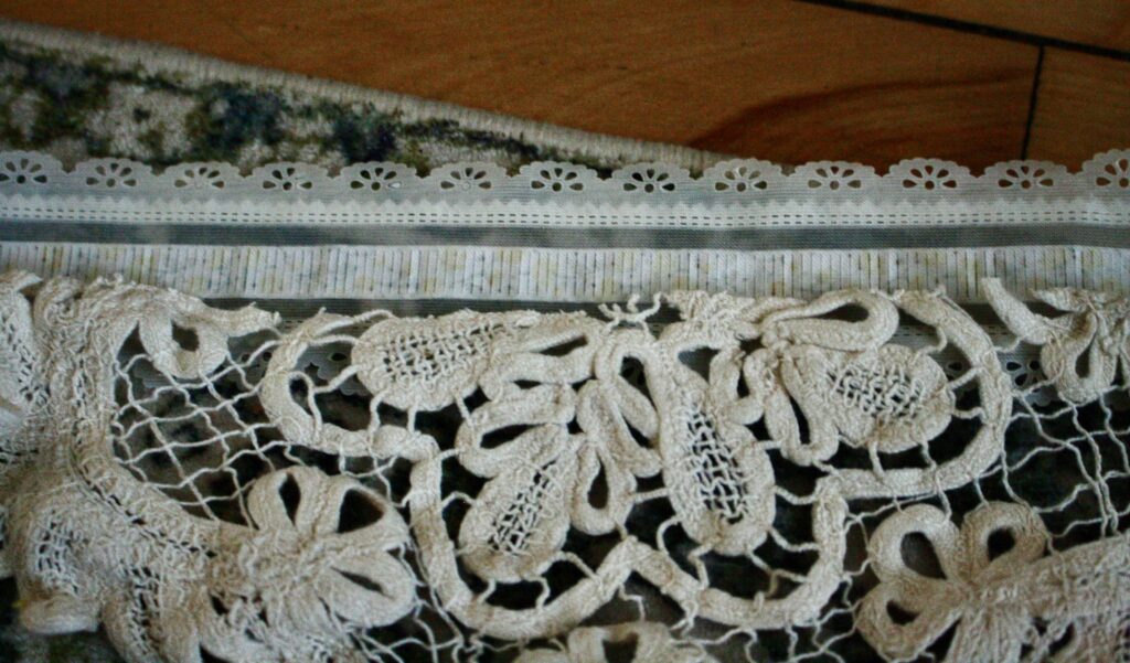 raw edge of lace laying on top of ribbon