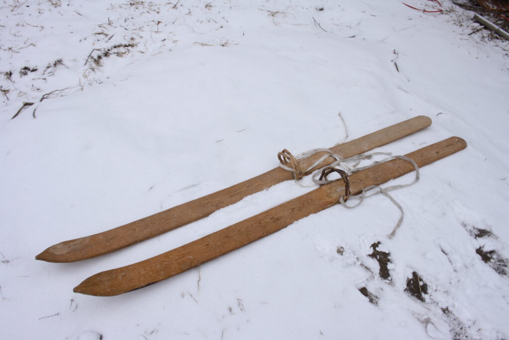 a pair of wooden medieval-style skis sitting on the snow